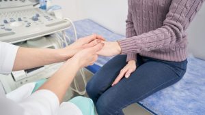 Doctor holding a patient's hand checking for a pulse