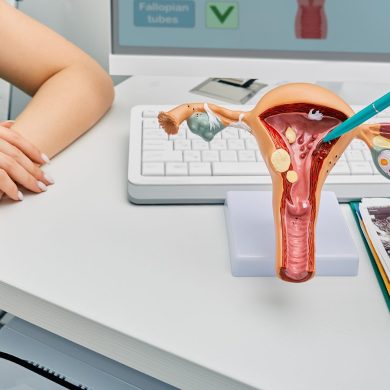 A nurse and doctor discuss endometriosis symptoms by using a physical model of the uterus