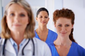 Endometriosis Patient Resources and Support Systems 15 Blurred endometriosis specialist and nurse in foreground with in-focus nurse centred between them in the background.