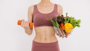 Diet and Lifestyle Changes That May Help Manage Endometriosis Symptoms 12 A young woman in exercise clothing holds a dumbbell and salad