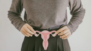 Understanding Endometriosis Pain: Types, Triggers, and Coping Strategies 14 A woman holds up a paper cutout of a uterus, fallopian tubes, and ovaries