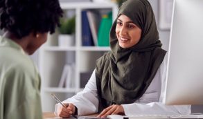 How to Advocate for Yourself in the Medical System When You Have Endometriosis 13 Woman at doctor's office speaking to clinician about endometriosis symptoms