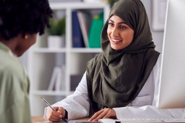 Woman at doctor's office speaking to clinician about endometriosis symptoms