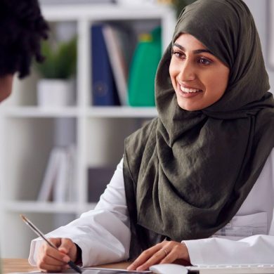 Woman at doctor's office speaking to clinician about endometriosis symptoms